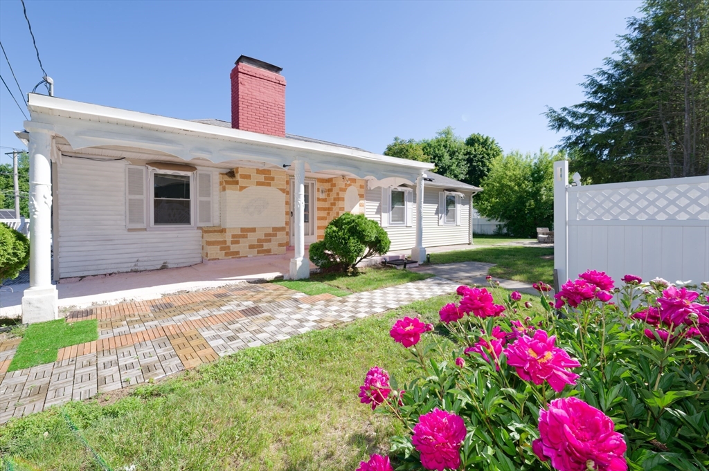 1 Rockland Rd Court Auburn, MA 01501 - Photo 1 of 38 a front view of a house with flower garden