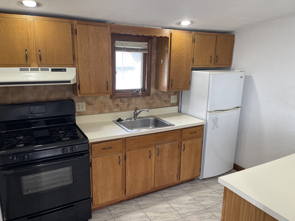 9 Gilmore Street, Unit 3 Everett, MA 02149 - Photo 4 of 11 a kitchen with a sink stove and refrigerator