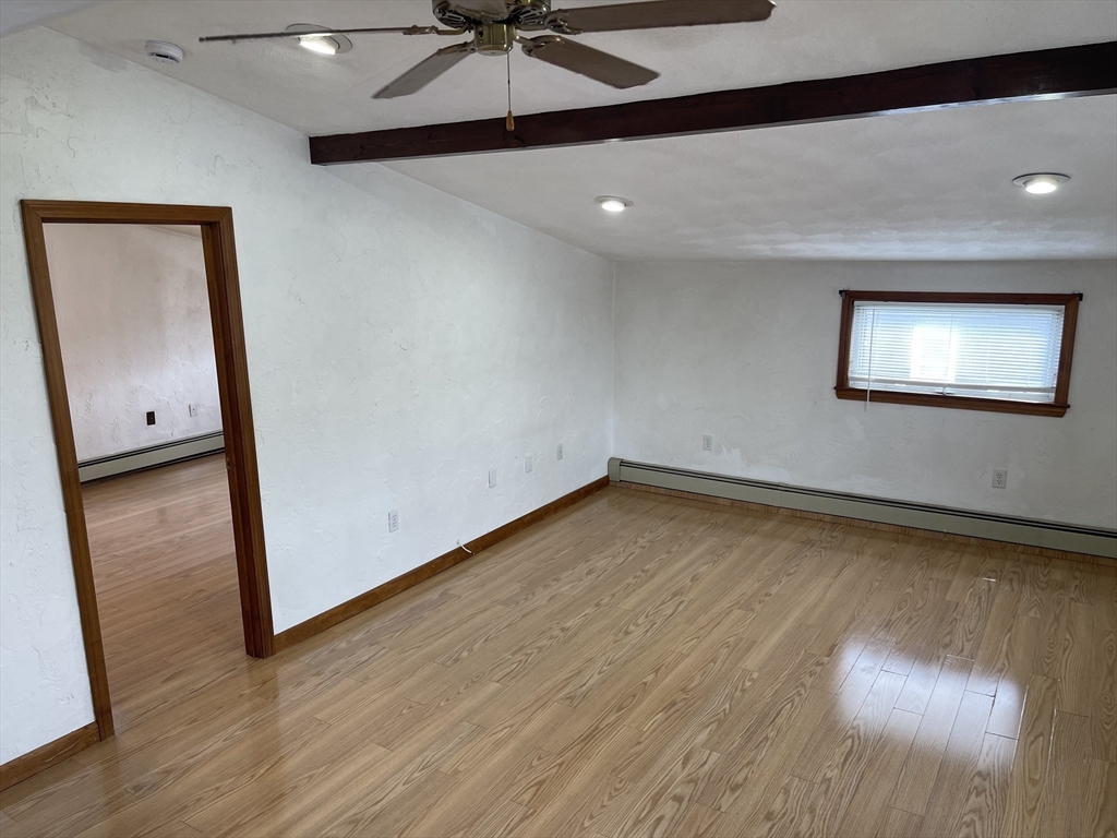 9 Gilmore Street, Unit 3 Everett, MA 02149 - Photo 5 of 11 an empty room with wooden floor fan and windows
