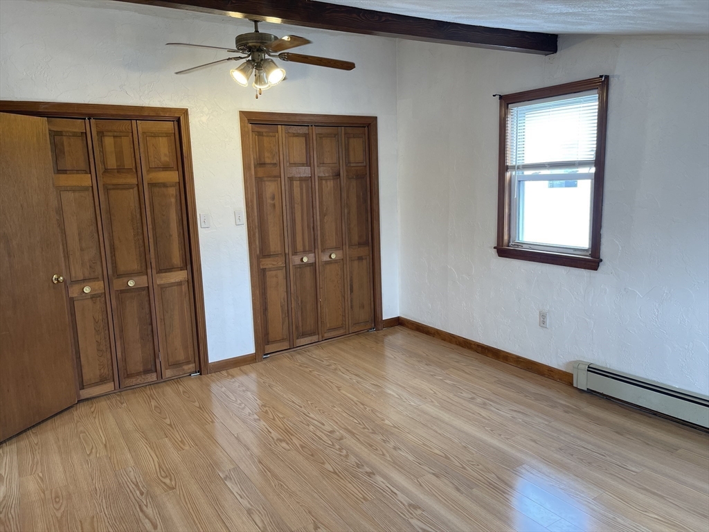 9 Gilmore Street, Unit 3 Everett, MA 02149 - Photo 6 of 11 an empty room with wooden floor closet and windows