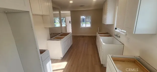 a bathroom with a sink a toilet a shower and a window