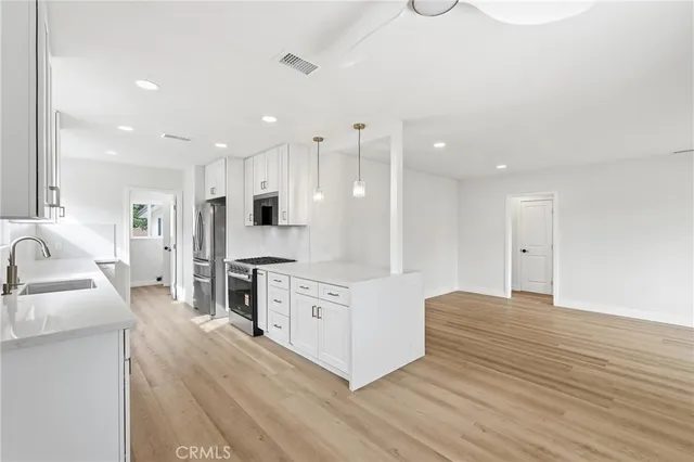 a kitchen with white cabinets and white appliances