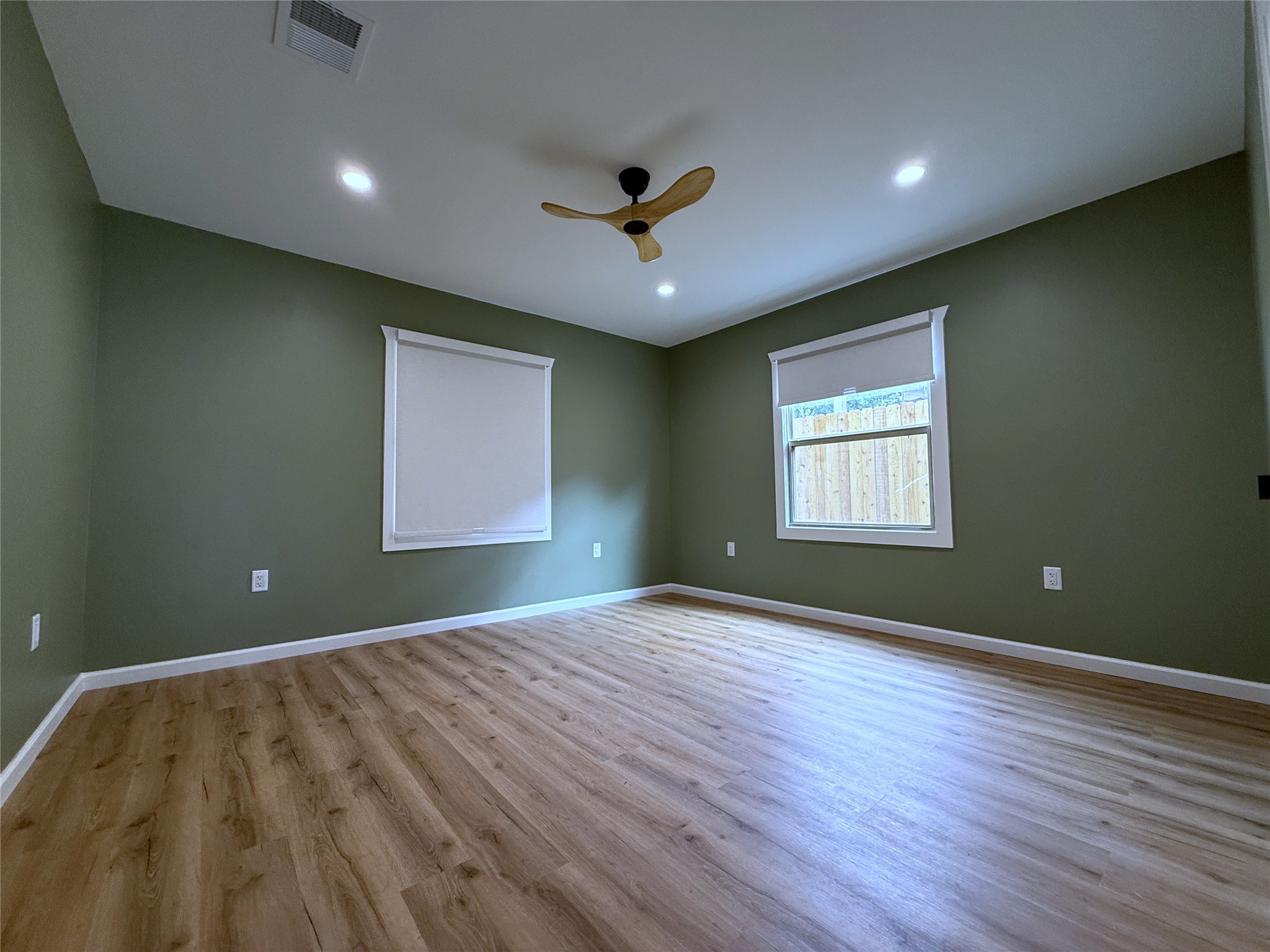 1922 Tabor Street Houston, TX 77009 - Photo 15 of 24 The side/back secondary bedroom with recessed lighting & remote controlled ceiling fan. Notice, the window shades are blackout.