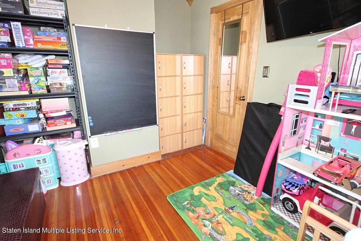 36 Cornell Street Staten Island, NY 10302 - Photo 23 of 31 a view of a bedroom with baby crib and toys