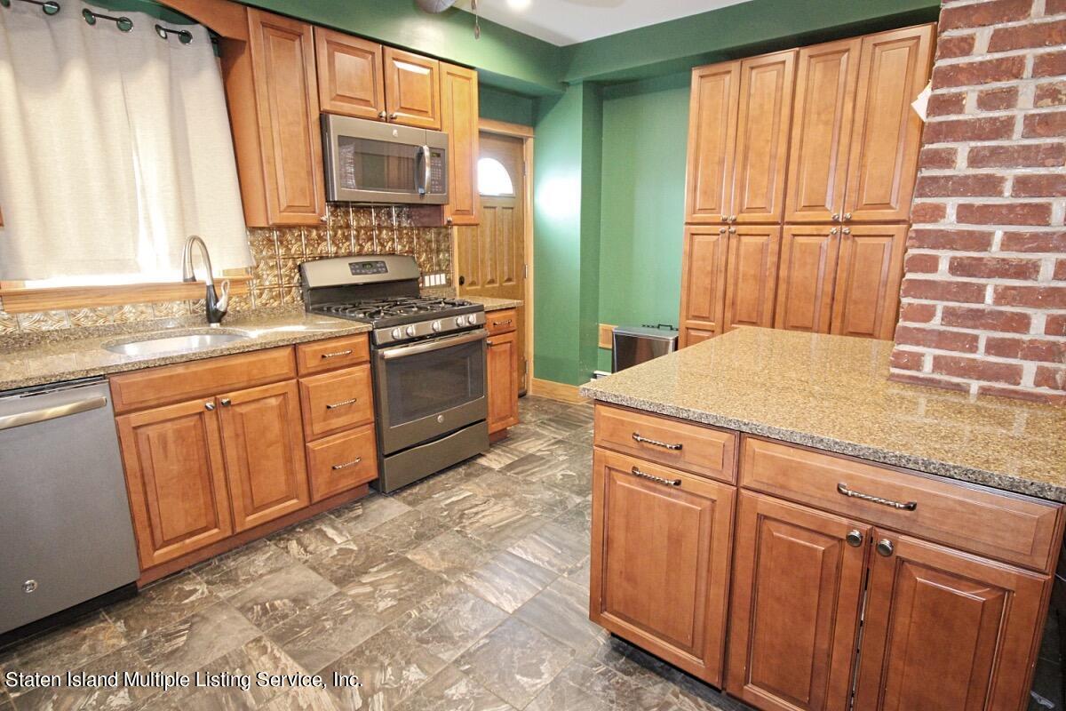 36 Cornell Street Staten Island, NY 10302 - Photo 4 of 31 a kitchen with stainless steel appliances granite countertop wooden cabinets a sink and a window