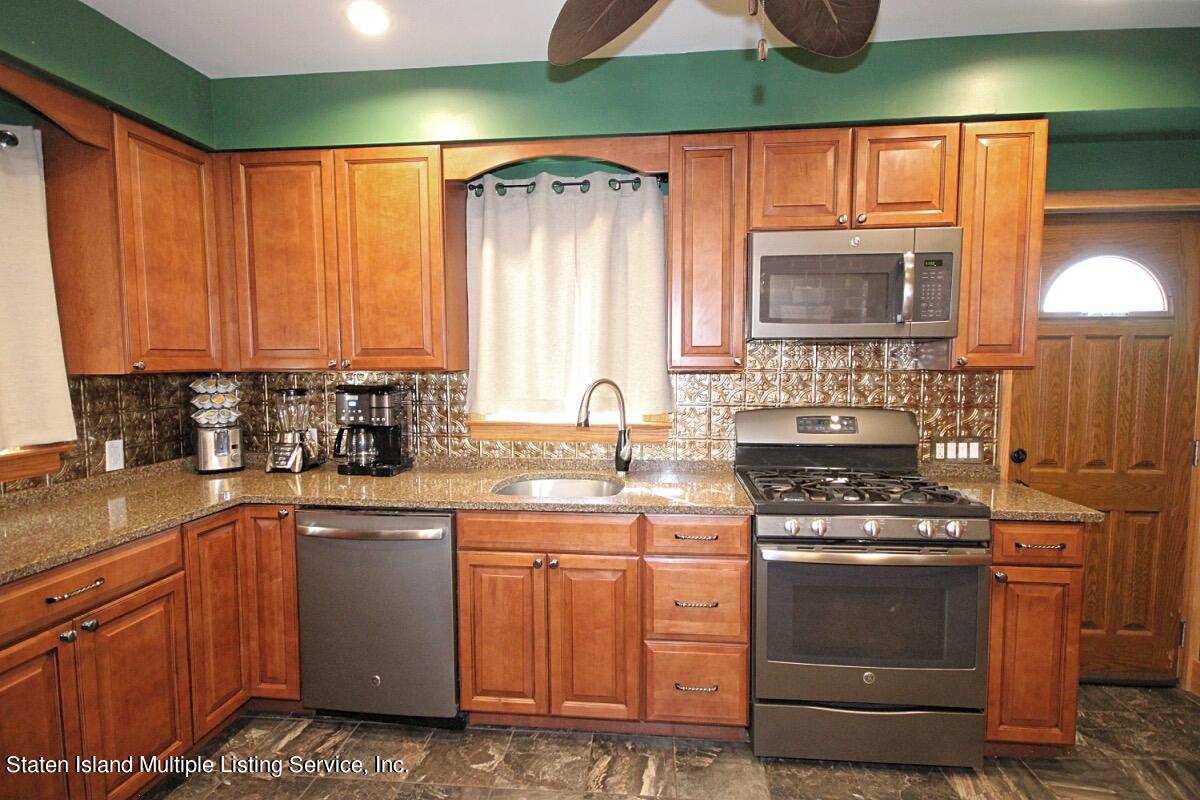 36 Cornell Street Staten Island, NY 10302 - Photo 5 of 31 a kitchen with a stove a sink and a microwave