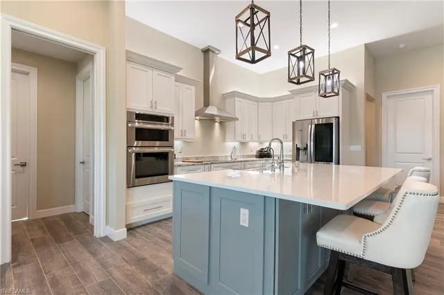 a kitchen with a sink cabinets and appliances