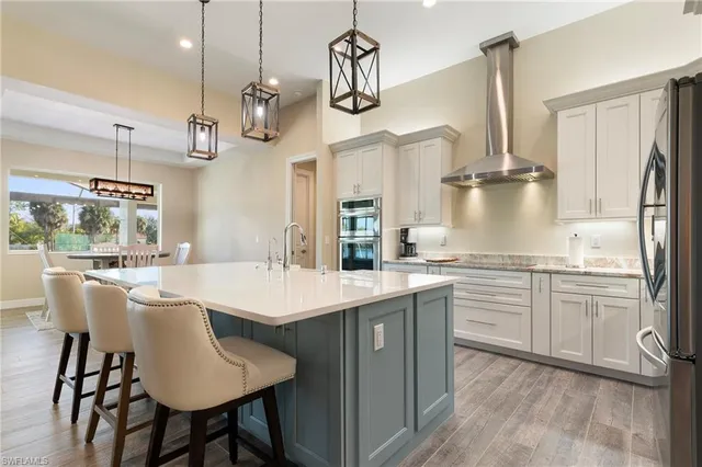 a kitchen with kitchen island granite countertop a sink a center island and appliances