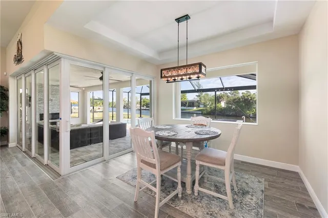 a view of a dining room with furniture wooden floor and chandelier