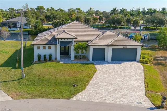 a aerial view of a house with swimming pool and view of a house