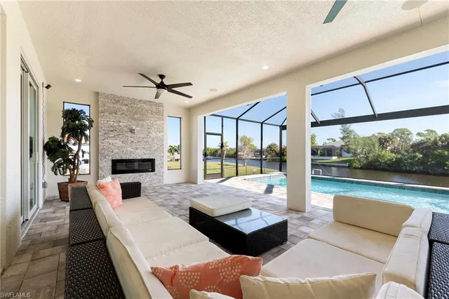 a living room with fireplace furniture and a large window
