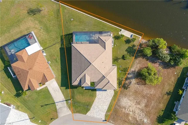 an aerial view of a house with swimming pool