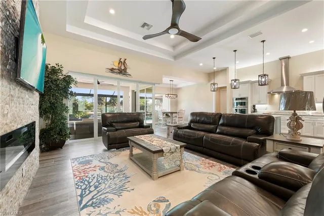 a living room with furniture kitchen view and a fireplace
