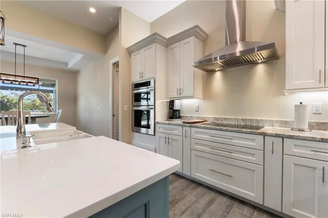 a kitchen with kitchen island a sink stove and cabinets