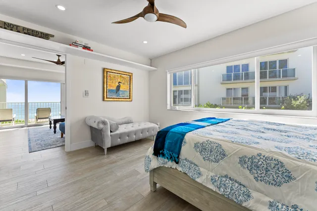 a bedroom with a bed wooden floor and window
