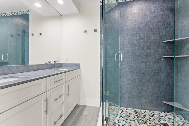 a bathroom with a shower and a sink