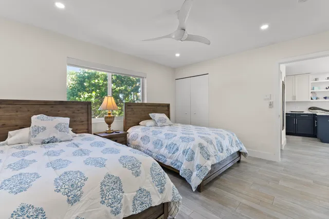 a bedroom with two beds and a dresser