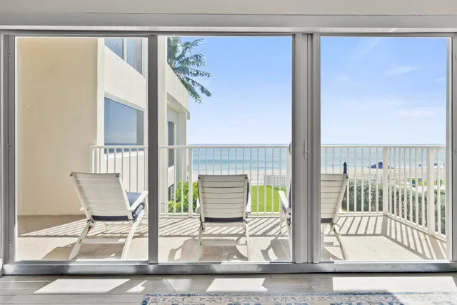a view of living room with furniture and floor to ceiling window