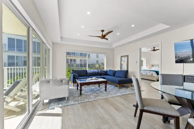 a living room with furniture a flat screen tv and a table