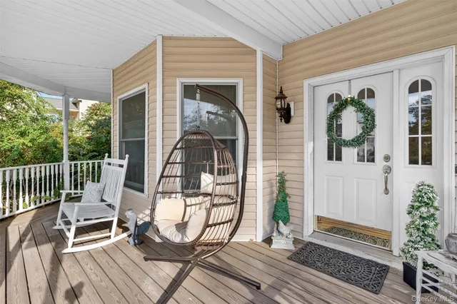 a view of a brick house with many windows plants and large tree