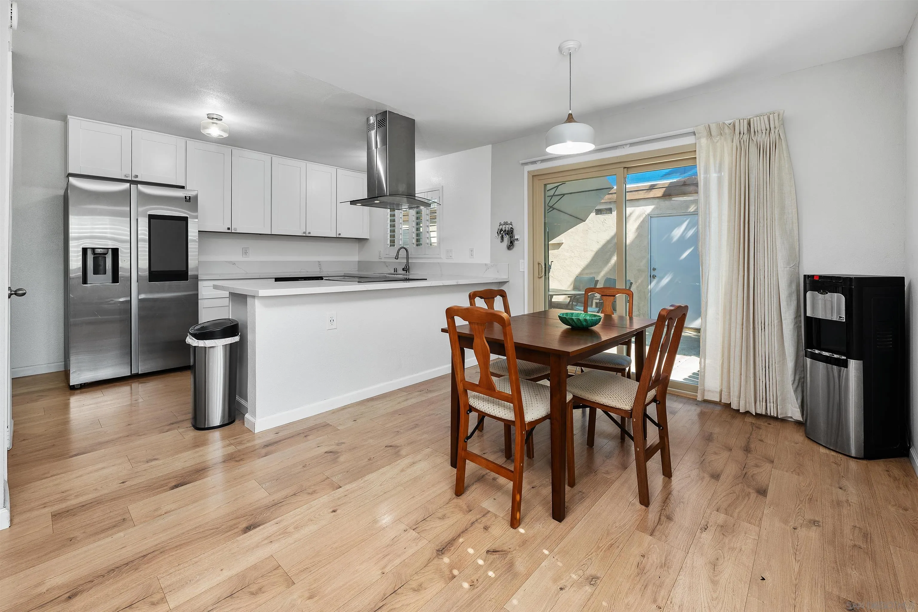 8325 Panorama Ridge Court Spring Valley, CA 91977 - Photo 12 of 39 a dining area with stainless steel appliances kitchen island granite countertop a dining table chairs and granite counter tops