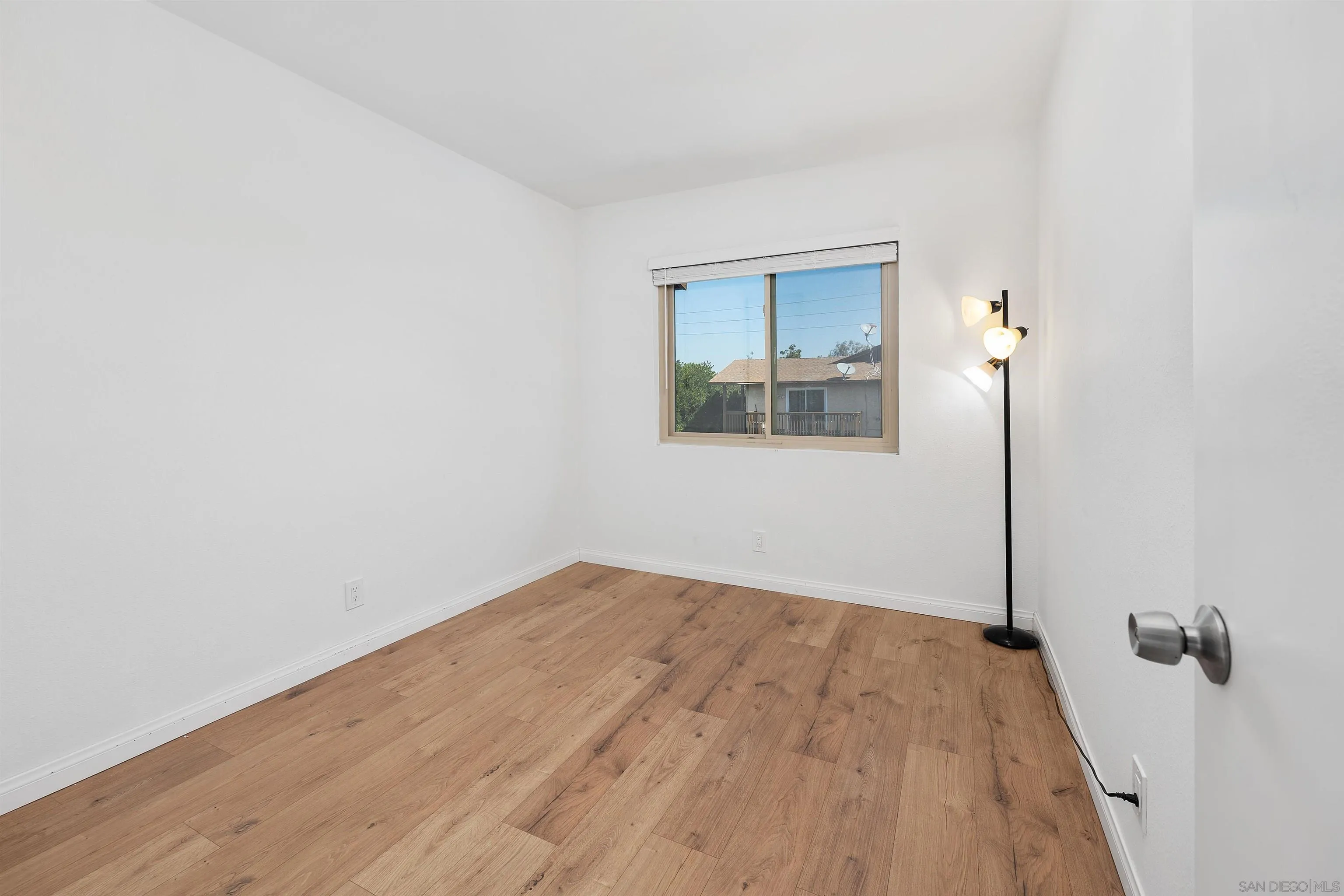 8325 Panorama Ridge Court Spring Valley, CA 91977 - Photo 23 of 39 an empty room with wooden floor and a window