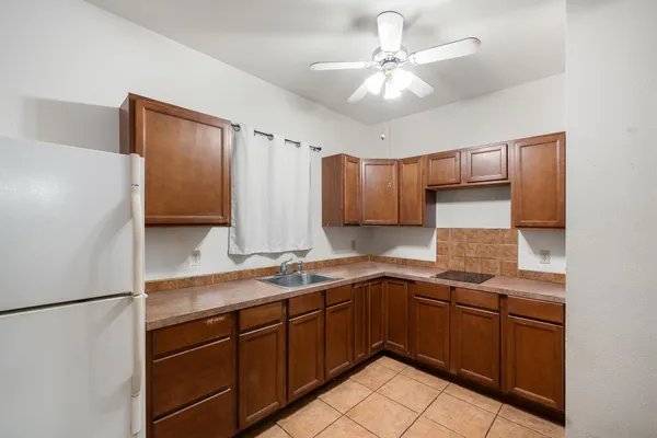 a kitchen with a sink appliances and cabinets