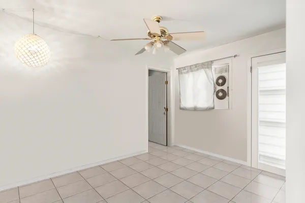 a view of an entryway and chandelier fan