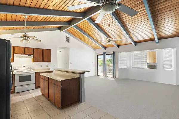 a kitchen with a stove a sink and a refrigerator