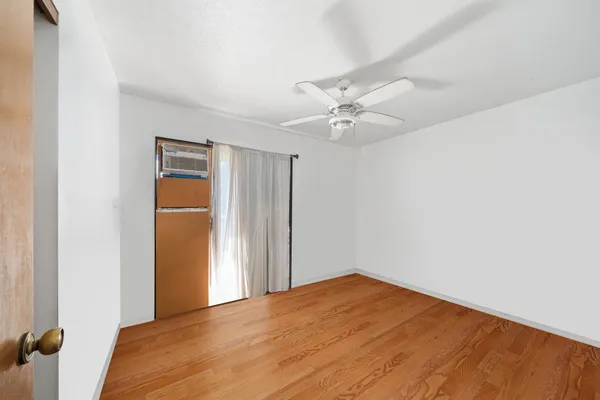 a view of a room with a ceiling fan