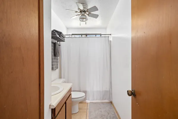 a bathroom with a shower a toilet and a sink