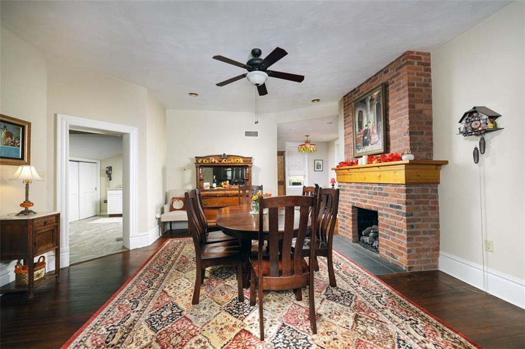 230 West Main Street Ligonier, PA 15658 - Photo 11 of 50 a dining room with furniture a rug a fireplace and a chandelier