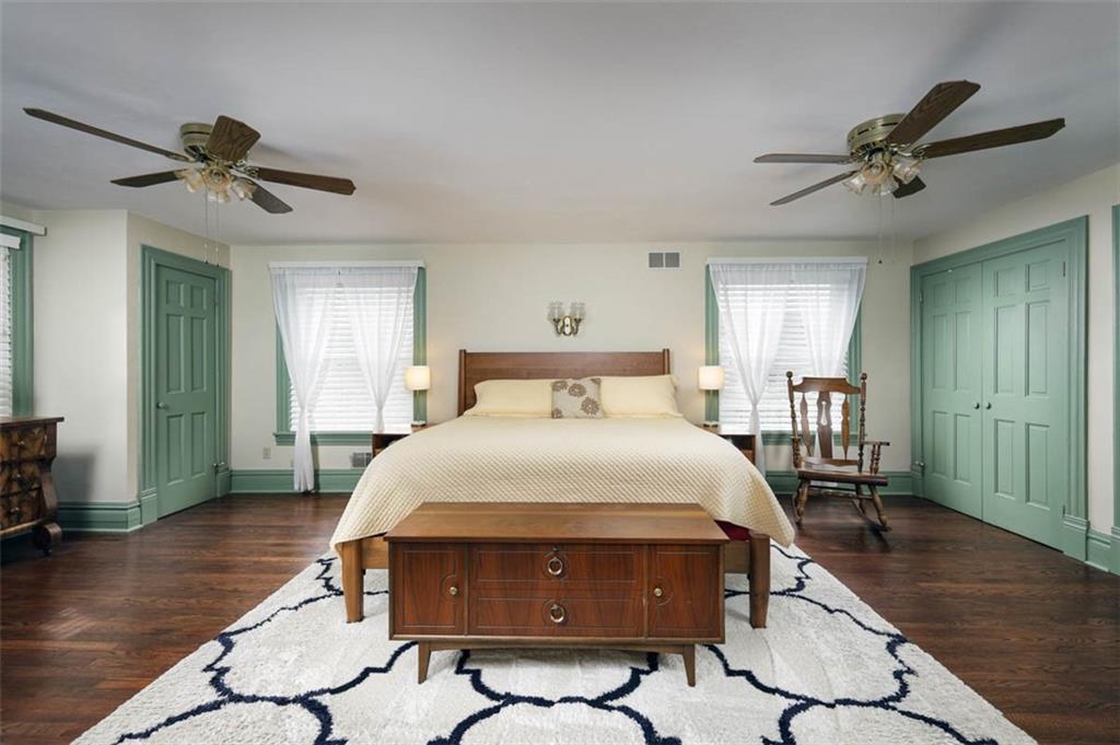230 West Main Street Ligonier, PA 15658 - Photo 22 of 50 a bedroom with a bed and a chandelier