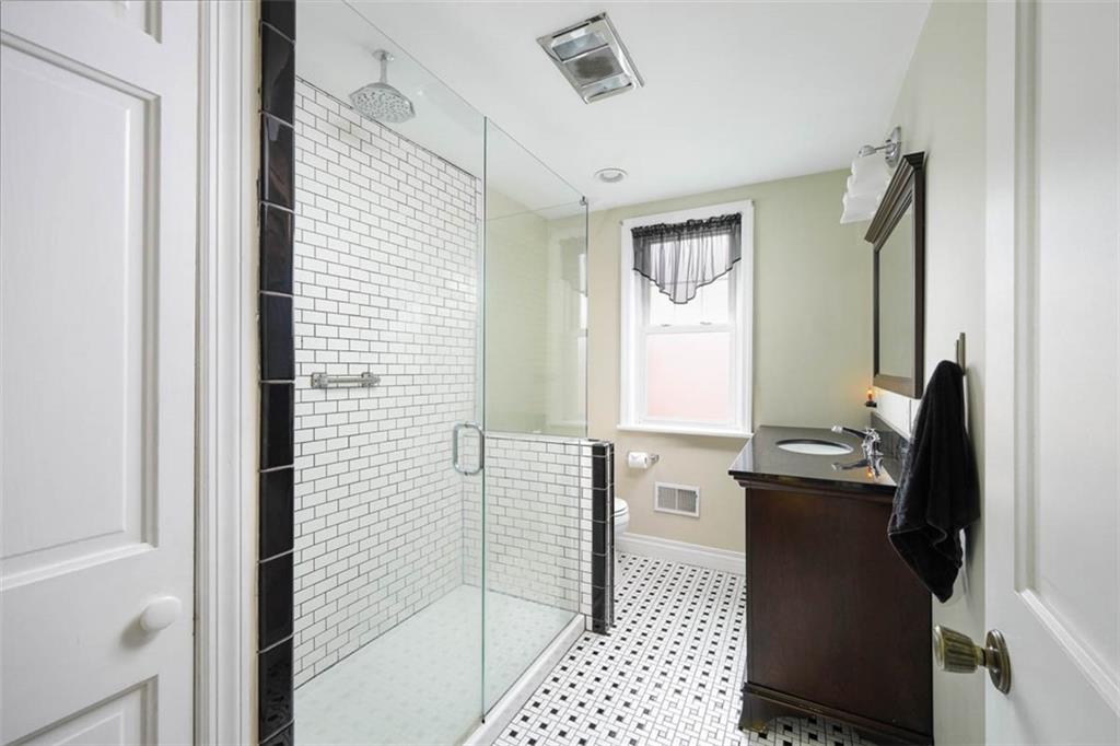 230 West Main Street Ligonier, PA 15658 - Photo 25 of 50 a bathroom with a sink a mirror and a shower