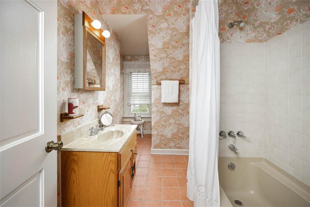 230 West Main Street Ligonier, PA 15658 - Photo 30 of 50 a bathroom with a sink a mirror and a bathtub