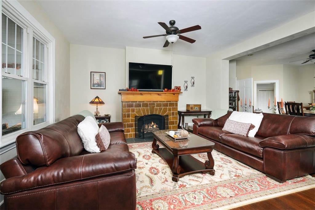 230 West Main Street Ligonier, PA 15658 - Photo 8 of 50 a living room with furniture a flat screen tv and a fireplace