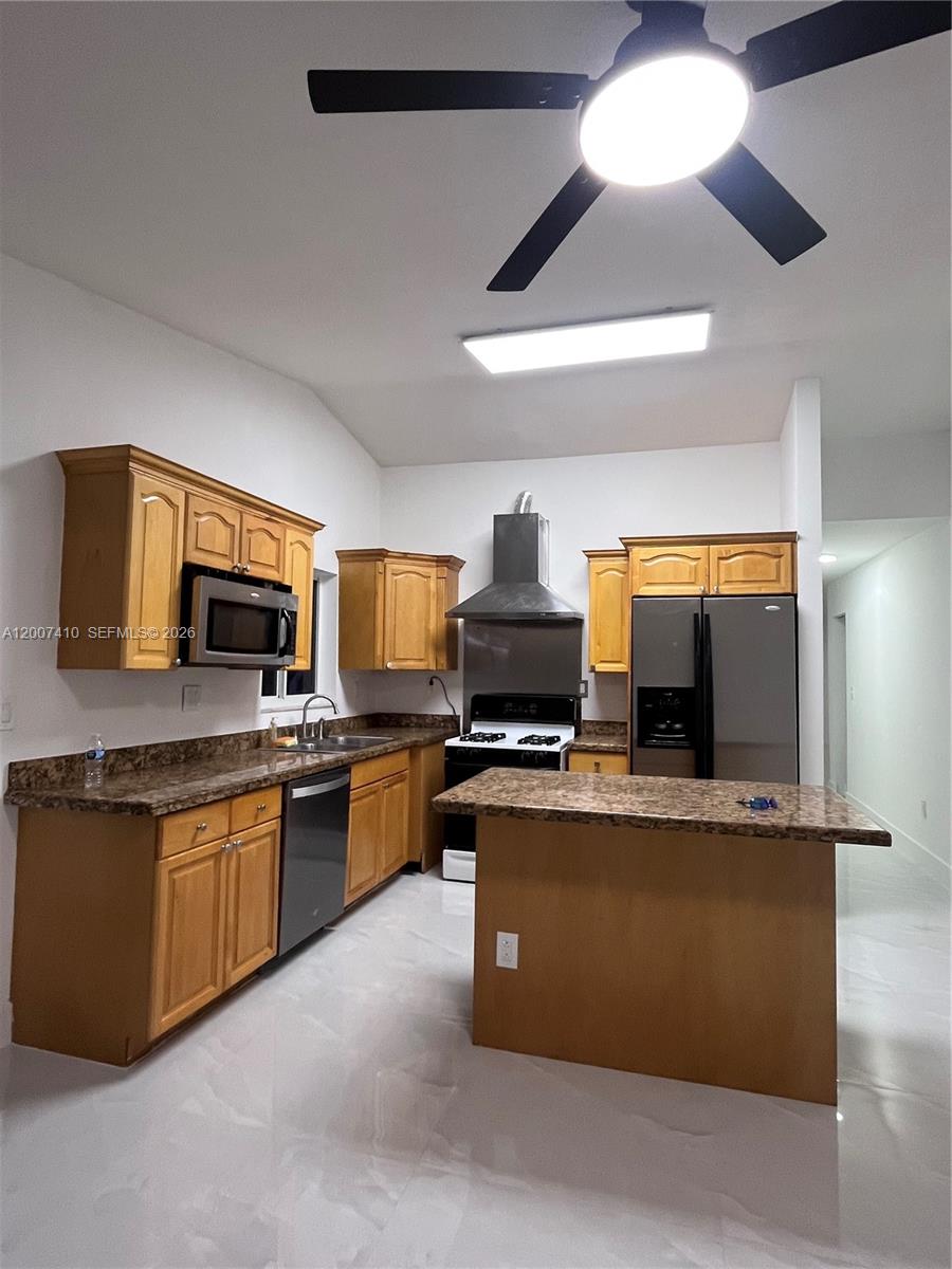 10058 Southwest 156th Court Miami, FL 33196 - Photo 3 of 13 a kitchen with stainless steel appliances granite countertop a stove top oven a sink dishwasher and a microwave oven on the blue kitchen countertops