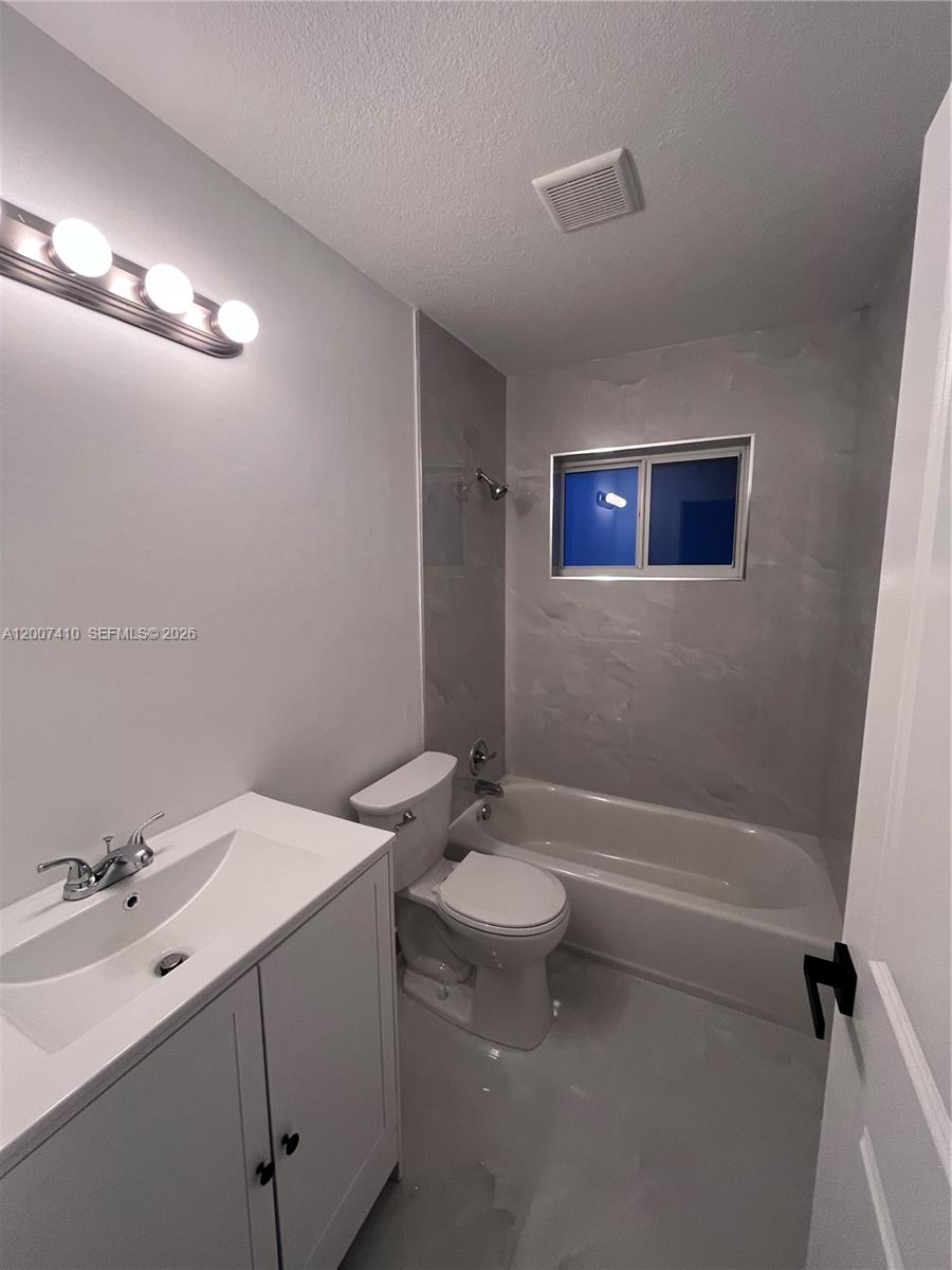 10058 Southwest 156th Court Miami, FL 33196 - Photo 8 of 13 a bathroom with a sink a toilet and shower
