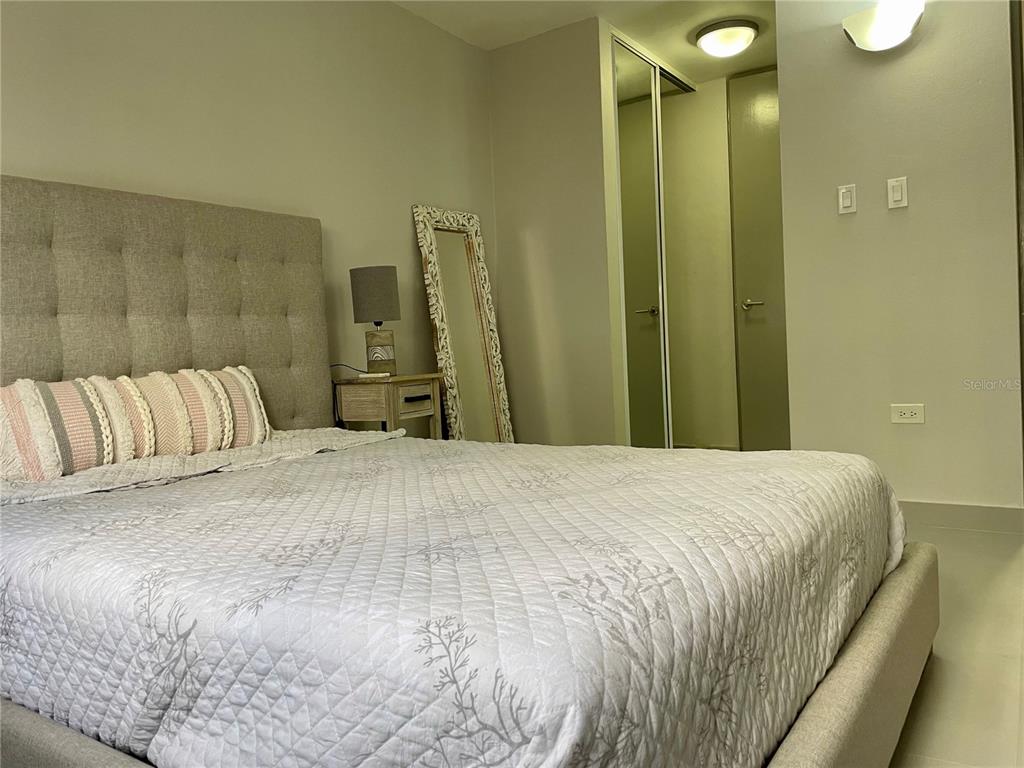 290 Av. Sta. Ana Guaynabo, Bayamón 00969 - Photo 12 of 23 a bedroom with a bed and a mirror