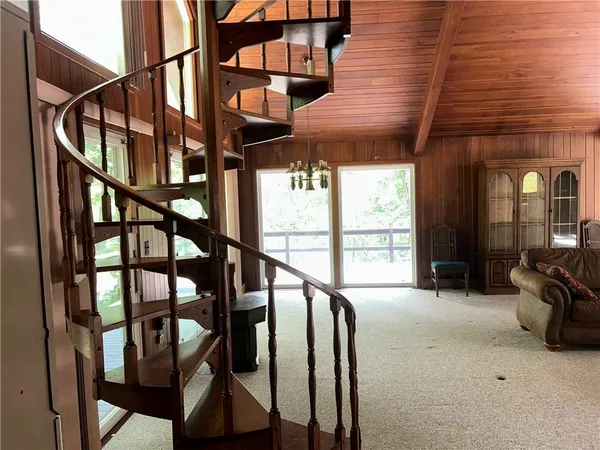a view of staircase with furniture and a window
