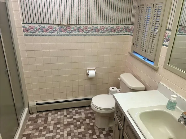 a bathroom with a sink a toilet and a shower