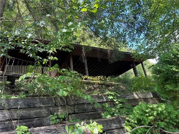 a wooden fence with some trees in the background
