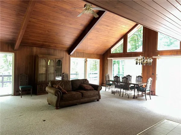 a living room with furniture and large windows