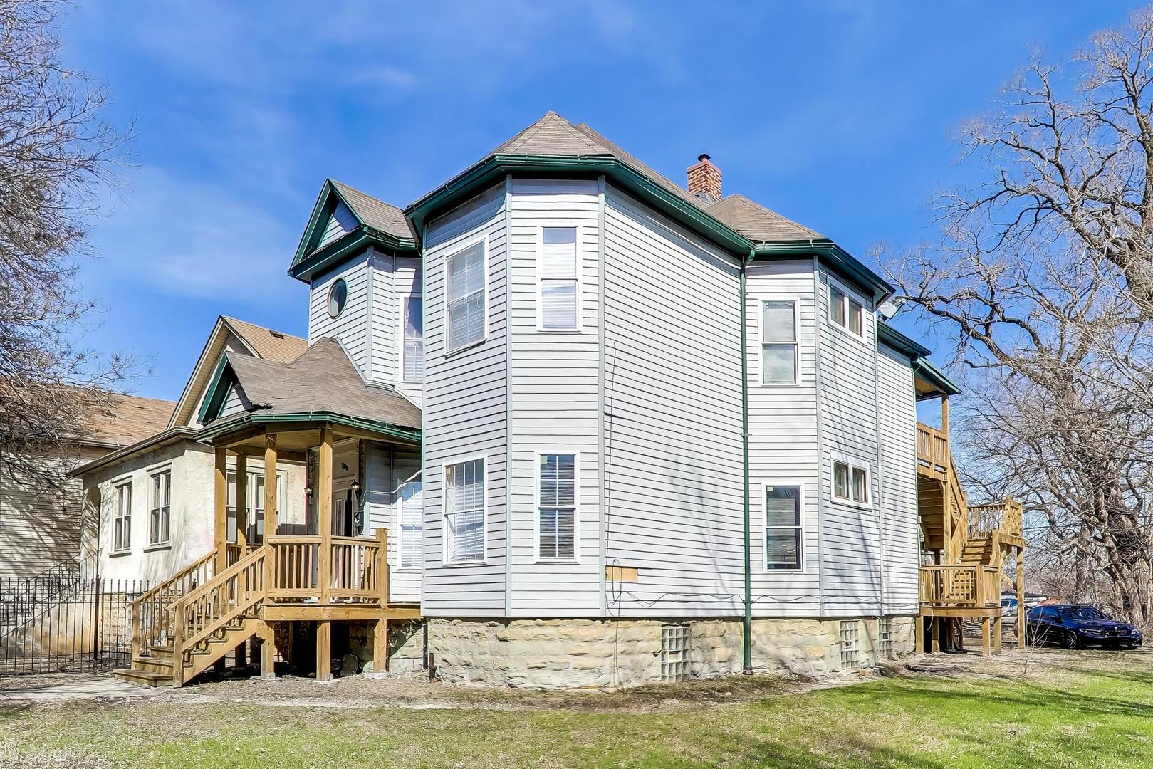 6853 South Perry Avenue Chicago, IL 60621 - Photo 2 of 28 a front view of a house with a yard