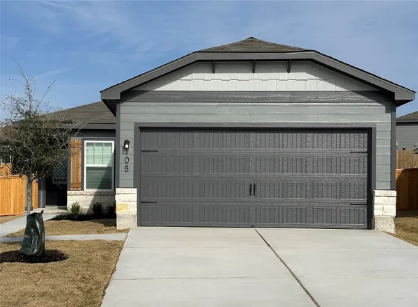 a front view of a house with a garage