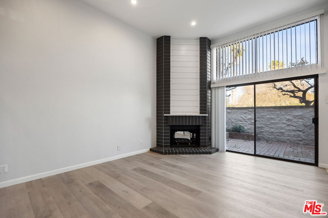 4631 Alla Road, Unit 8 Marina del Rey, CA 90292 - Photo 11 of 29 an empty room with wooden floor and fireplace