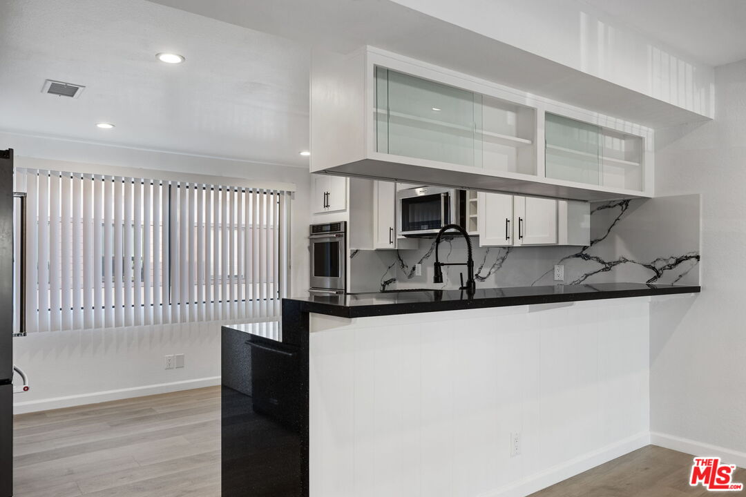 4631 Alla Road, Unit 8 Marina del Rey, CA 90292 - Photo 15 of 29 a kitchen with stainless steel appliances granite countertop a sink and a stove top oven