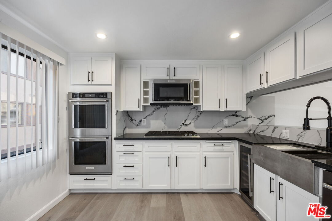4631 Alla Road, Unit 8 Marina del Rey, CA 90292 - Photo 19 of 29 a kitchen with granite countertop a sink stove and microwave