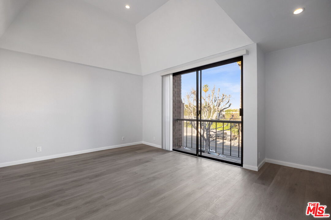 4631 Alla Road, Unit 8 Marina del Rey, CA 90292 - Photo 22 of 29 a view of an empty room with wooden floor and a window