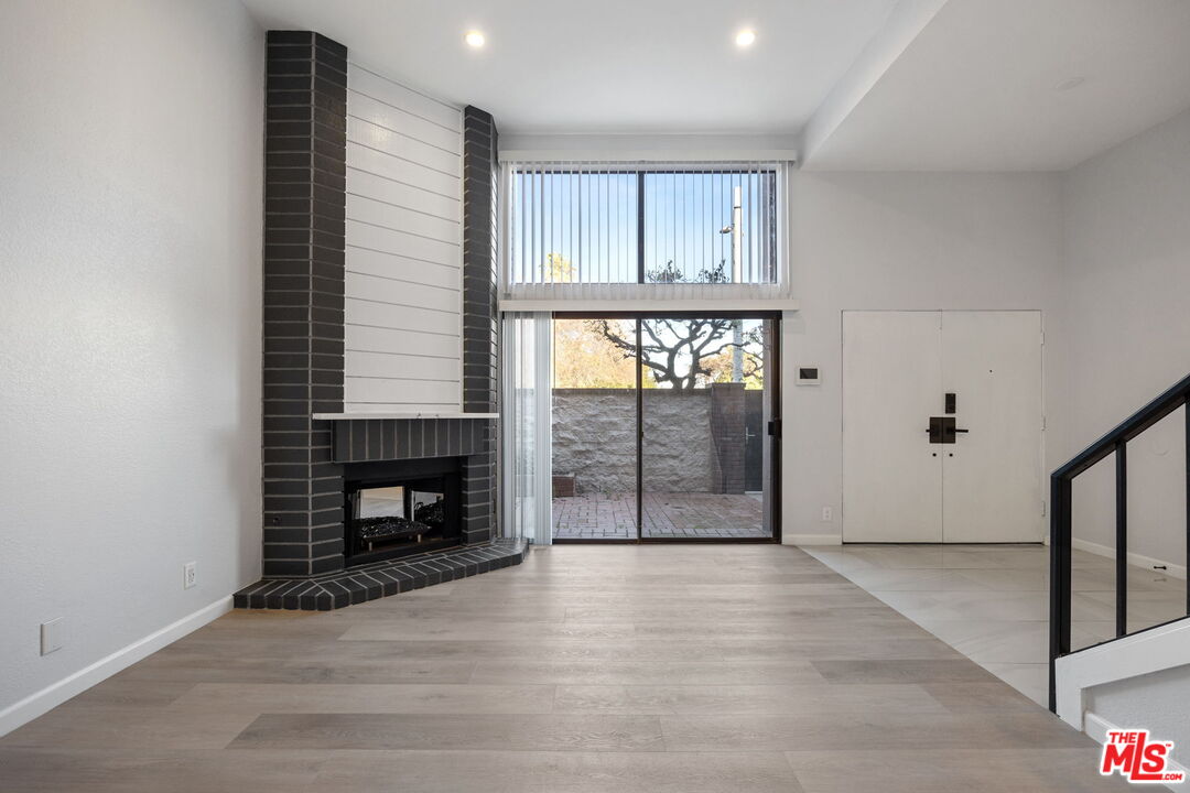 4631 Alla Road, Unit 8 Marina del Rey, CA 90292 - Photo 10 of 29 an empty room with wooden floor fireplace and windows
